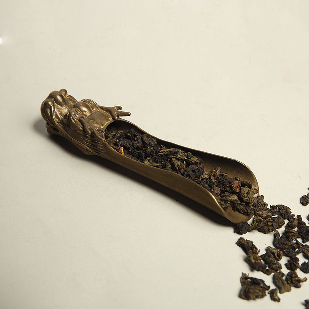 Copper dragon tea holder used on a tea table as part of a traditional tea ceremony setup