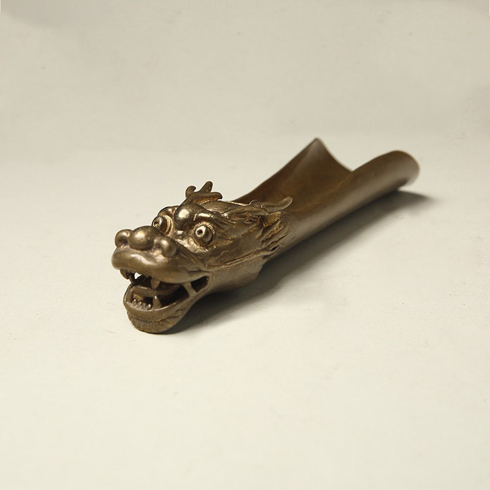 Elegant tea accessories including a decorative tea holder and tea leaf divider with dragon motif