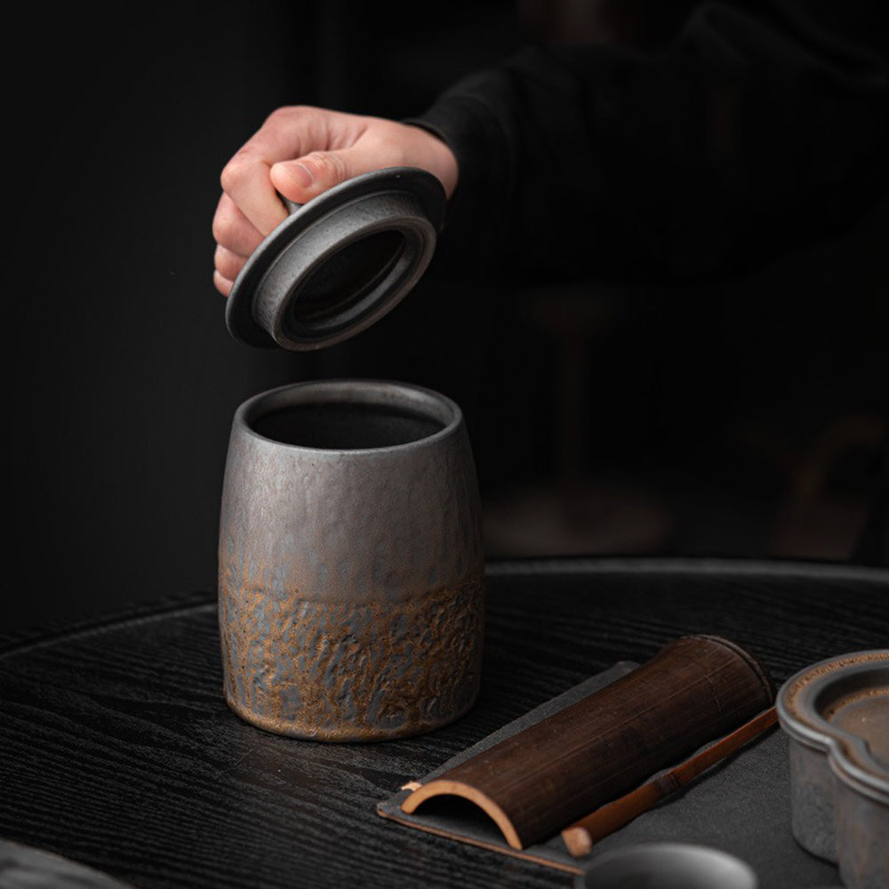 Rustic barn pottery tea caddy in a kitchen setting with tea leaves.