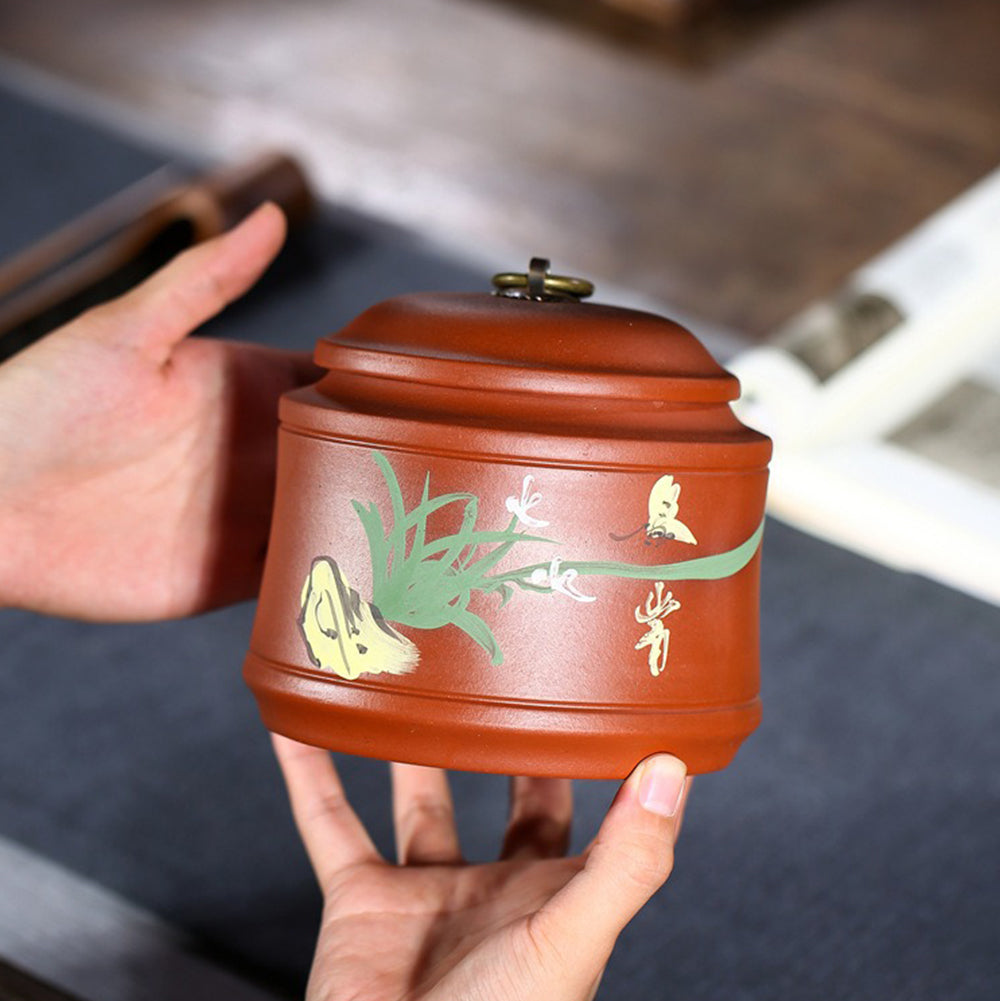 Close-up of handmade Yixing purple clay orchid tea caddy showing intricate texture and shape