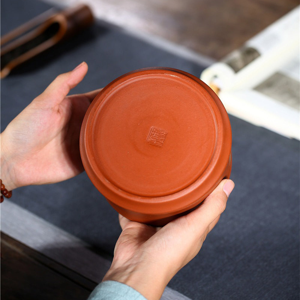 Elegant purple clay tea caddy on a tea table, highlighting traditional craftsmanship