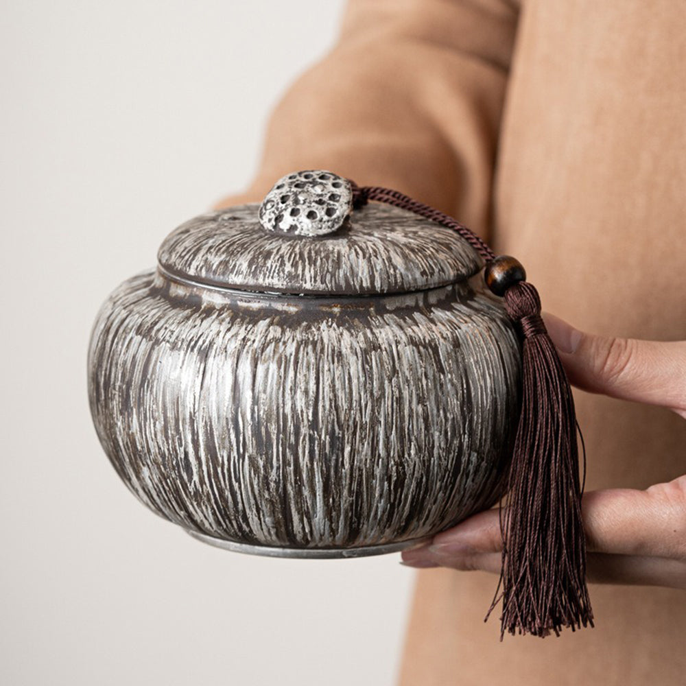 Handcrafted ceramic tea storage jar with decorative lid and traditional style