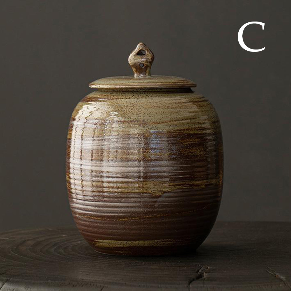 Close-up of the handmade pottery tea caddy with a lid, highlighting the unique glaze and texture.