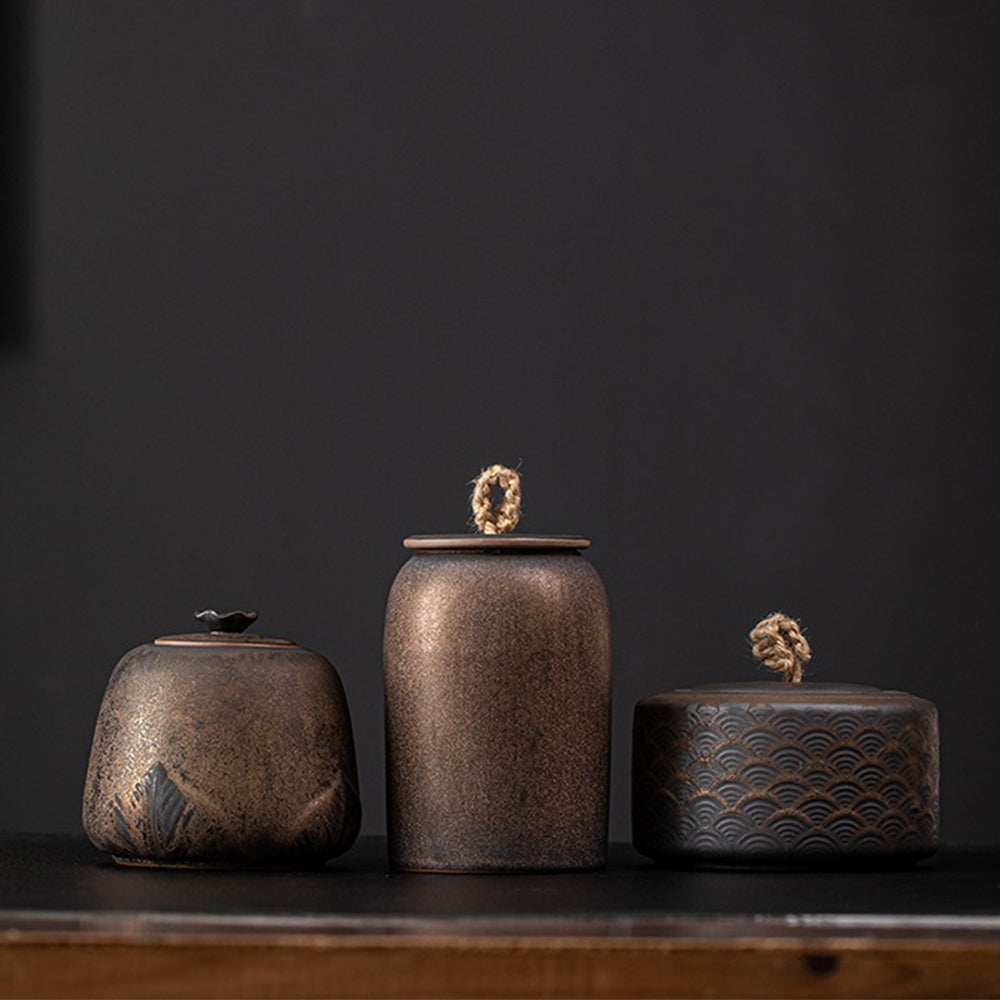 Close-up of handmade coarse pottery tea caddy showing textured surface and glaze finish