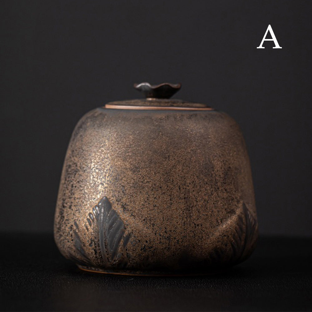 Tea caddy on a kitchen counter with loose tea leaves nearby, showcasing vintage design