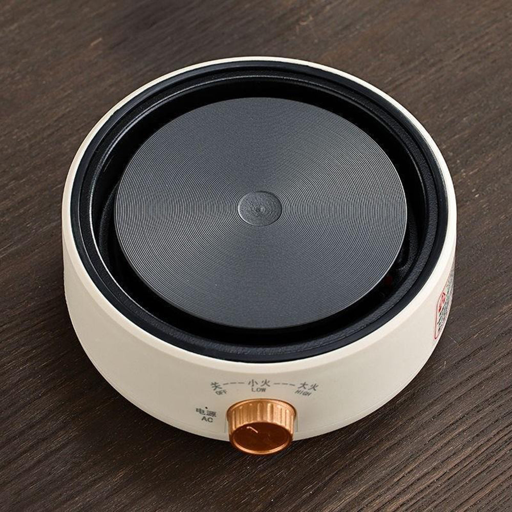 Portable electric teapot heater with temperature control, perfect for camping and outdoor use.