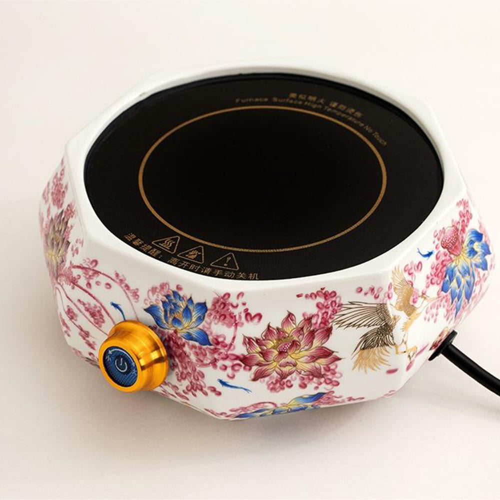 Lotus Electric Teapot Warmer displaying the ceramic shell and control buttons from an angled perspective.