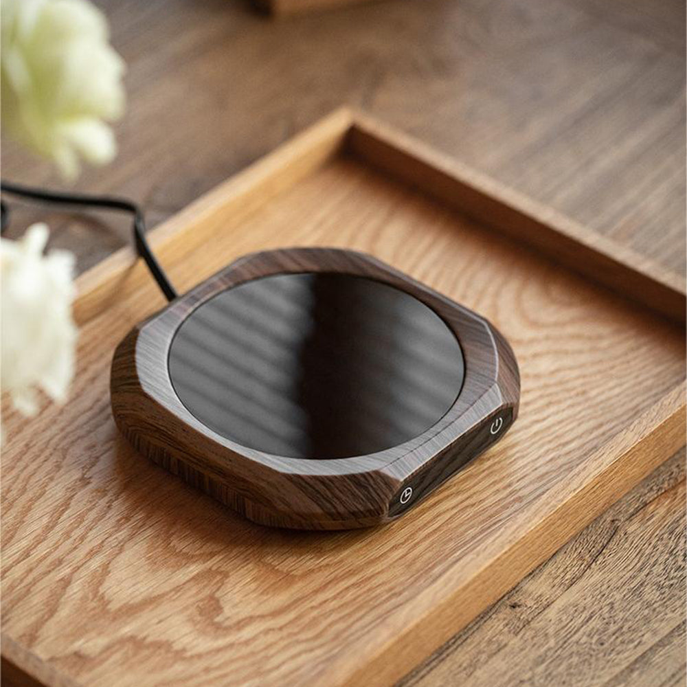 Portable tea warmer in use on office desk with ceramic mug