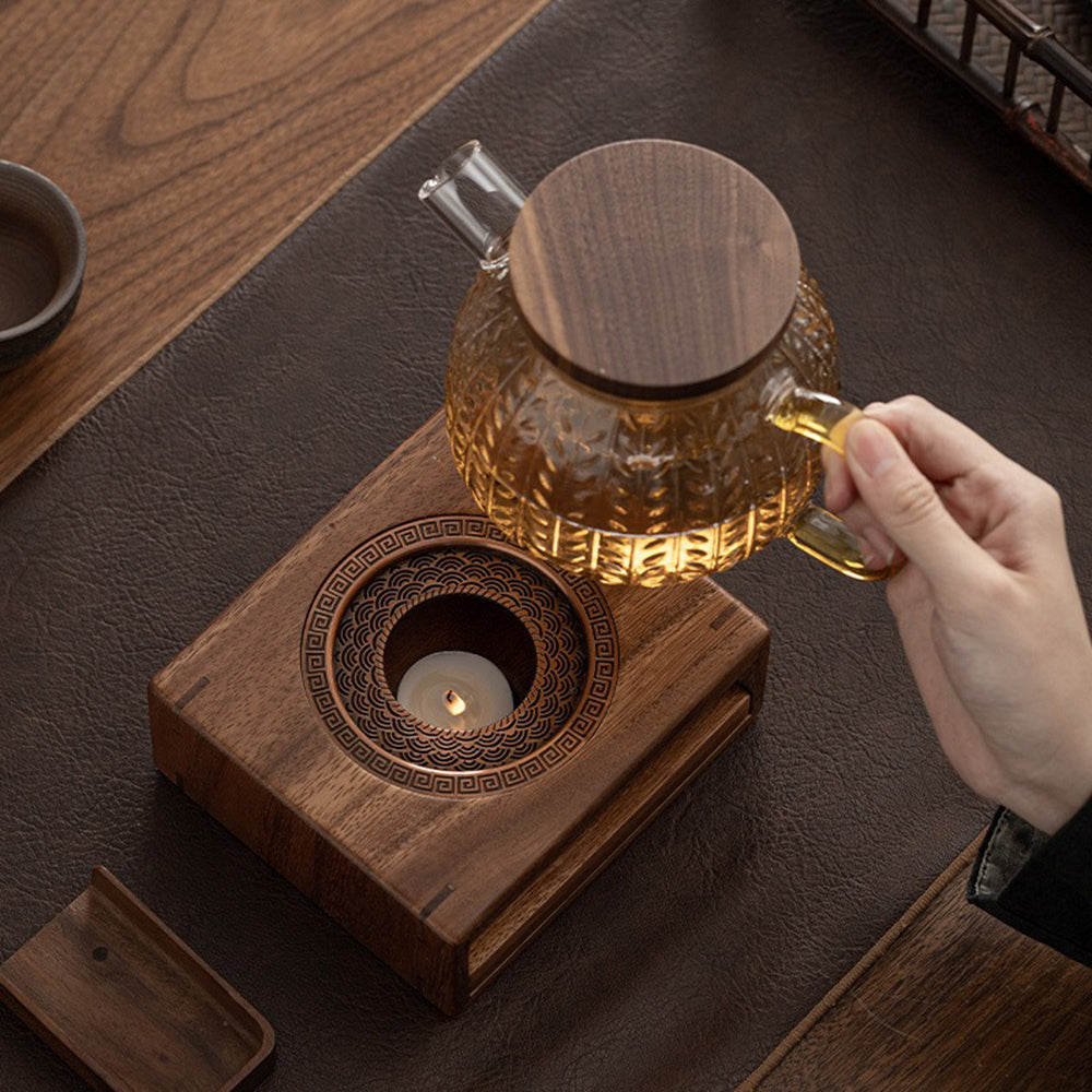 Elegant walnut wood teapot warmer with candle lit, displaying warm ambiance.