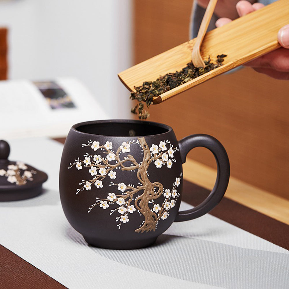 Close-up view of the color changing teacup showing the plum blossom pattern.