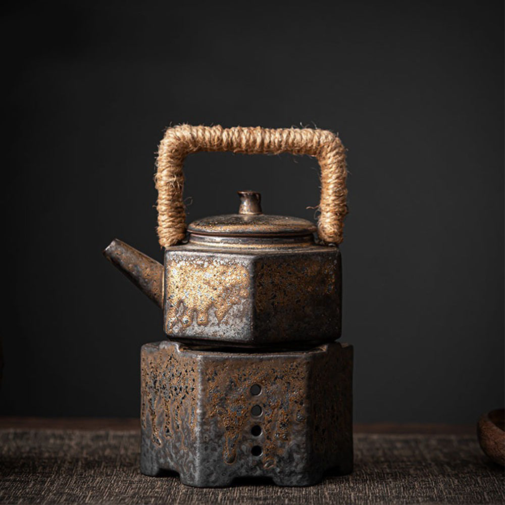 Close-up of vintage hexagon ceramic teapot with natural glaze and braided handle