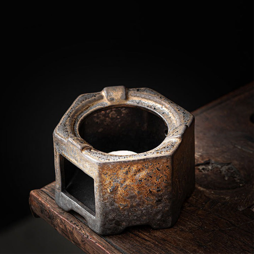 Close-up of vintage hexagon ceramic teapot with natural glaze and braided handle