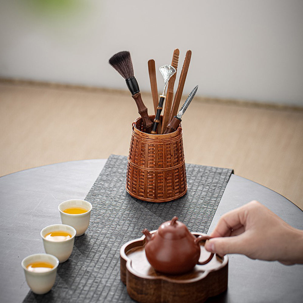 Bamboo tea utensils set with woven holder displayed elegantly