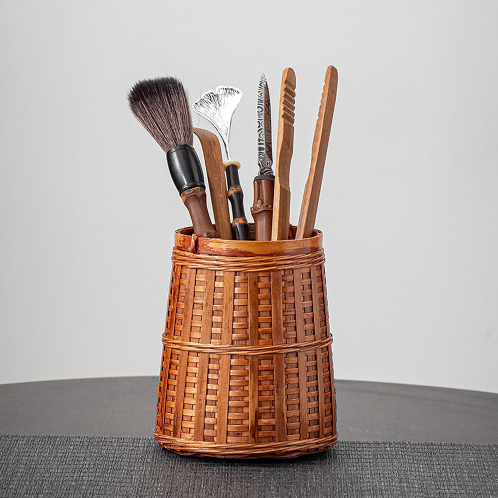Bamboo tea utensils set with woven holder displayed elegantly