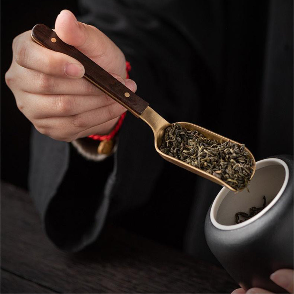 Close-up of ebony and copper tea utensils set with coasters, showcasing craftsmanship and materials
