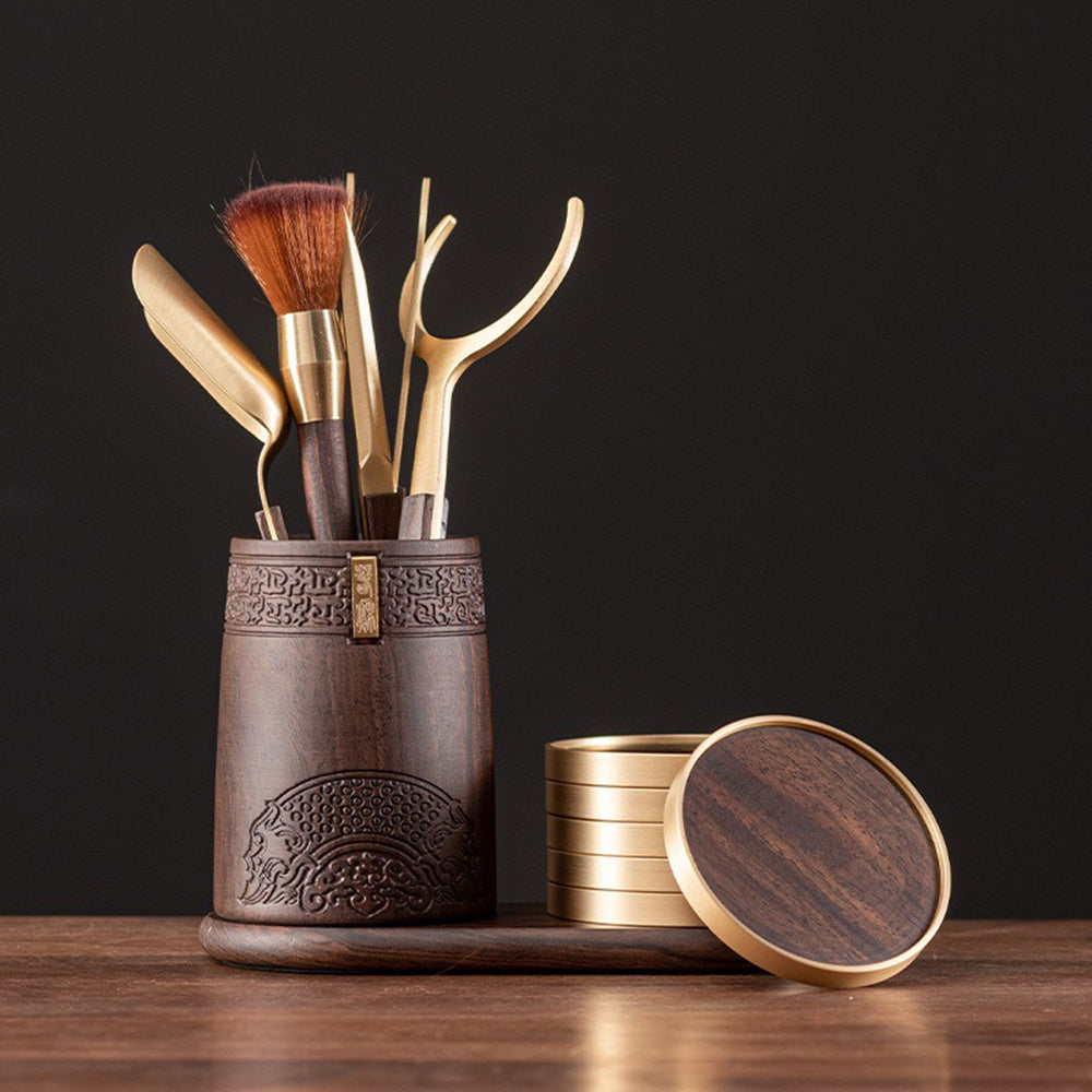 Ebony tea set with copper coasters and traditional carvings, ideal for tea ceremonies