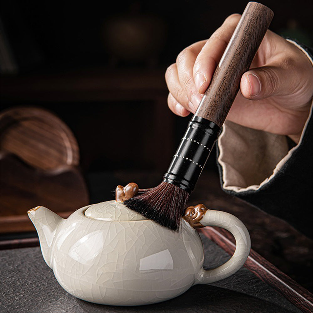 Close-up of walnut tea set holder with tools and coasters, highlighting natural wood grain