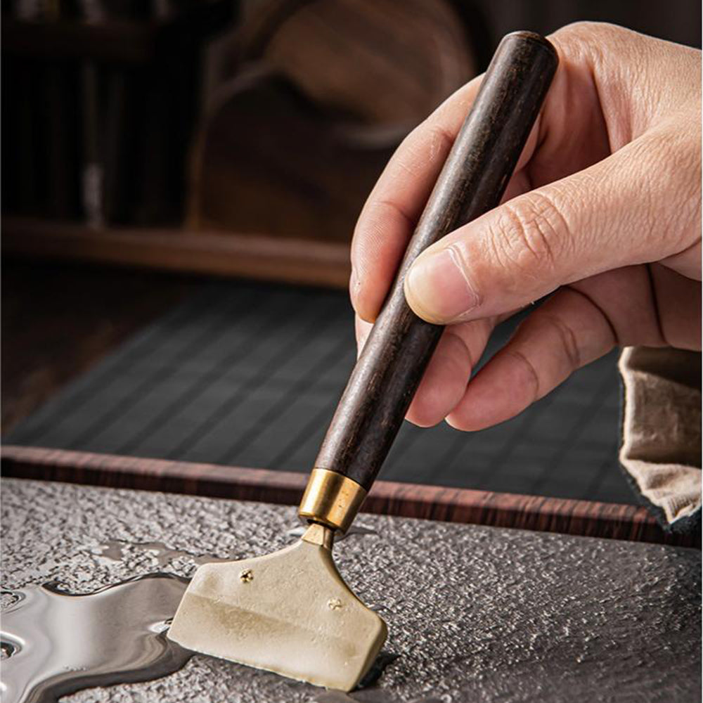 Close-up of walnut tea set holder with tools and coasters, highlighting natural wood grain