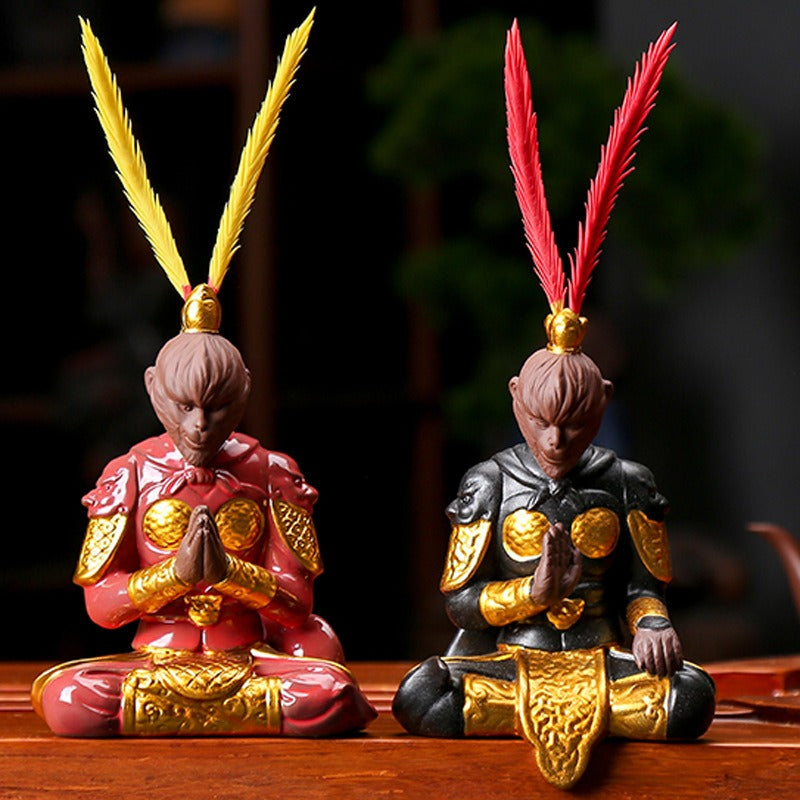 Ceramic Wukong figurine sitting cross-legged with golden hoop stick, detailed and colorful for tea decor