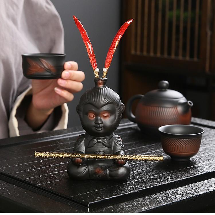 Close-up of Wukong tea figurine with detachable golden hoop stick.