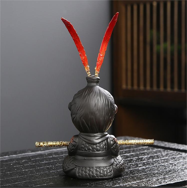 Close-up of Wukong tea figurine with detachable golden hoop stick.