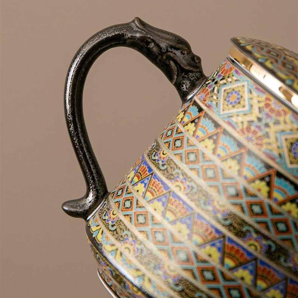 Front view of the ceramic mug showing dragon handle and strainer in place