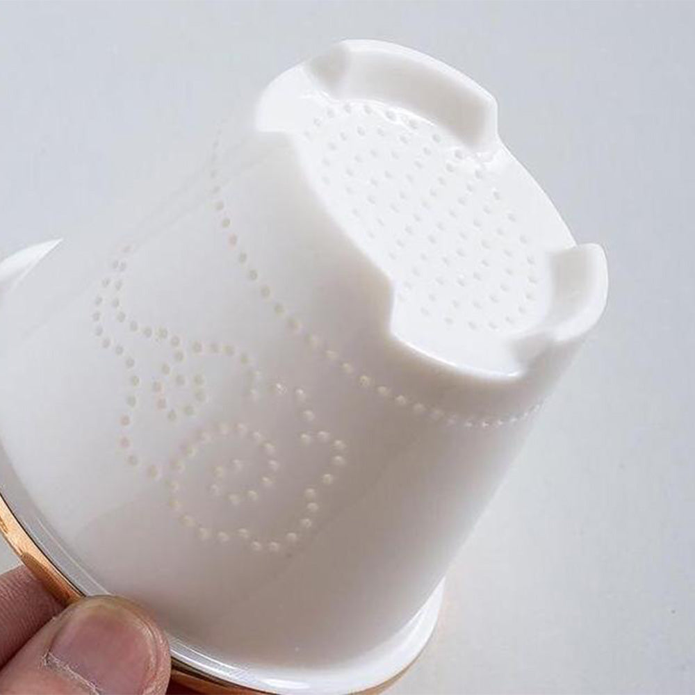 Side angle of the jade tea cup highlighting the gold-plated dragon handle and porcelain texture