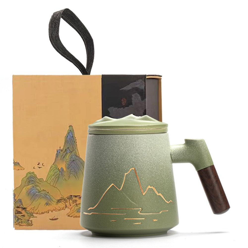 Close-up of the handmade ceramic tea cup with relief mountain design and frosted texture