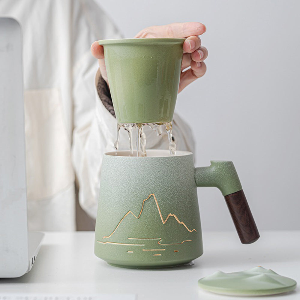 Tea brewing with ceramic mug featuring integrated strainer and wooden handle