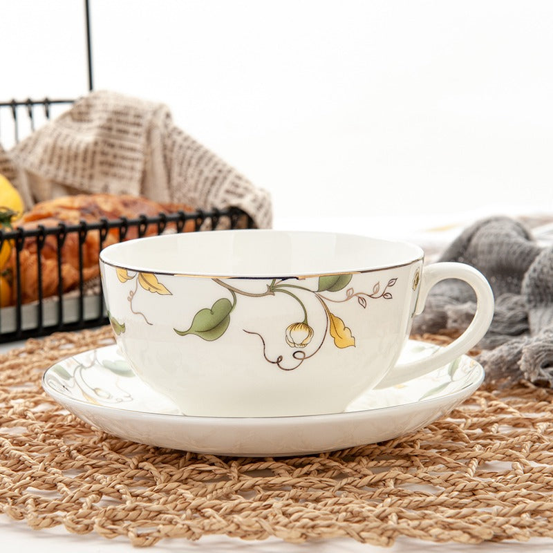 Elegant floral leaf bone china tea cup and saucer set displayed on a wooden table, perfect for afternoon tea.
