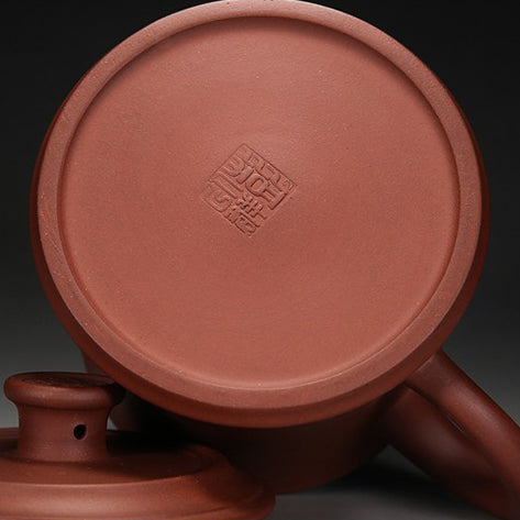 Yixing purple clay tea cup with traditional design and engravings