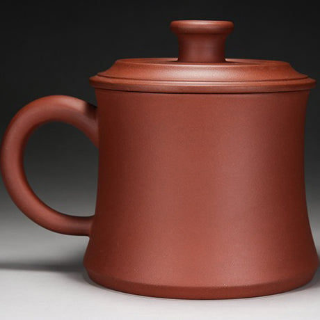 Tea brewing with an authentic purple clay cup in a cozy setting