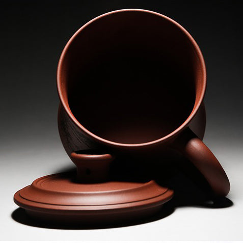 Yixing purple clay tea cup with traditional design and engravings