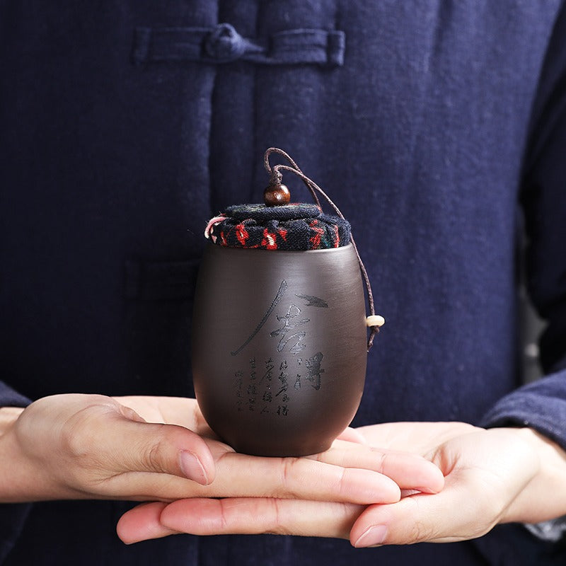 Close-up of the purple clay tea caddy, highlighting its airtight design for preserving tea freshness.