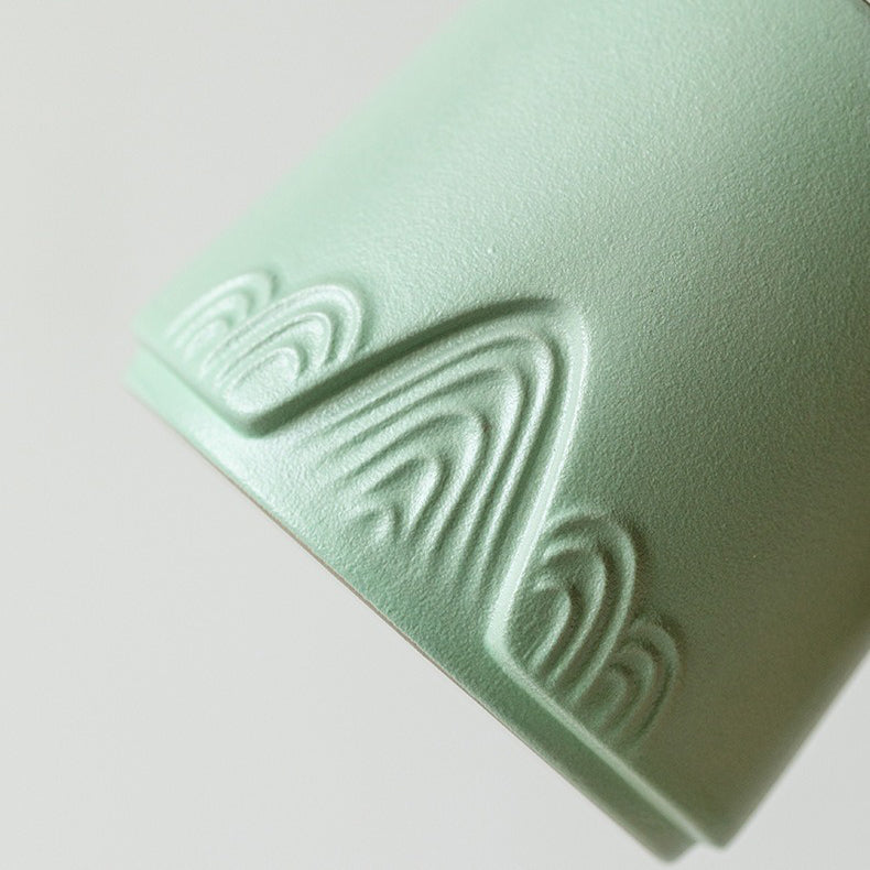 Close-up of traditional Japanese ceramic tea cup with wooden handle