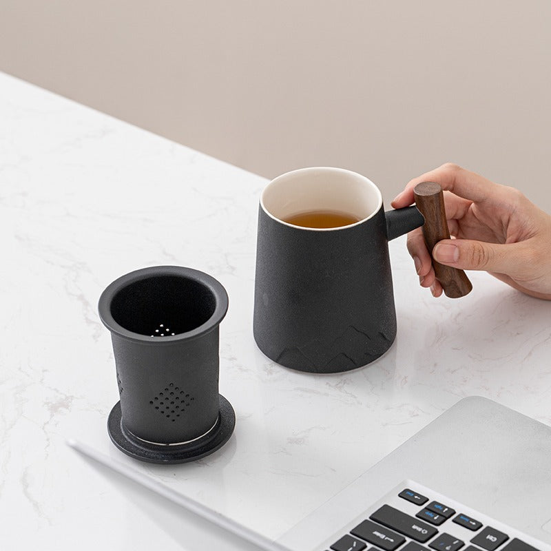 Japanese tea being poured into ceramic cup with wooden handle for a refined tea experience