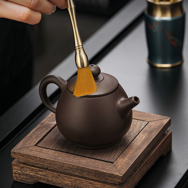 Close-up of colorful copper tea tools for Gong fu tea ceremony