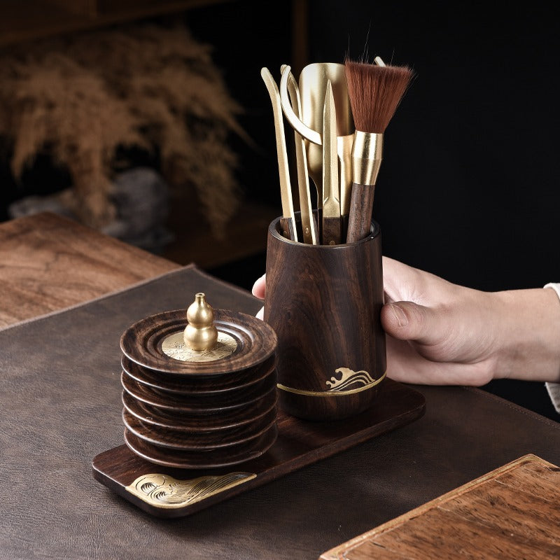 Close-up of the Gong Fu tea utensils including a spoon, funnel, and tweezers.