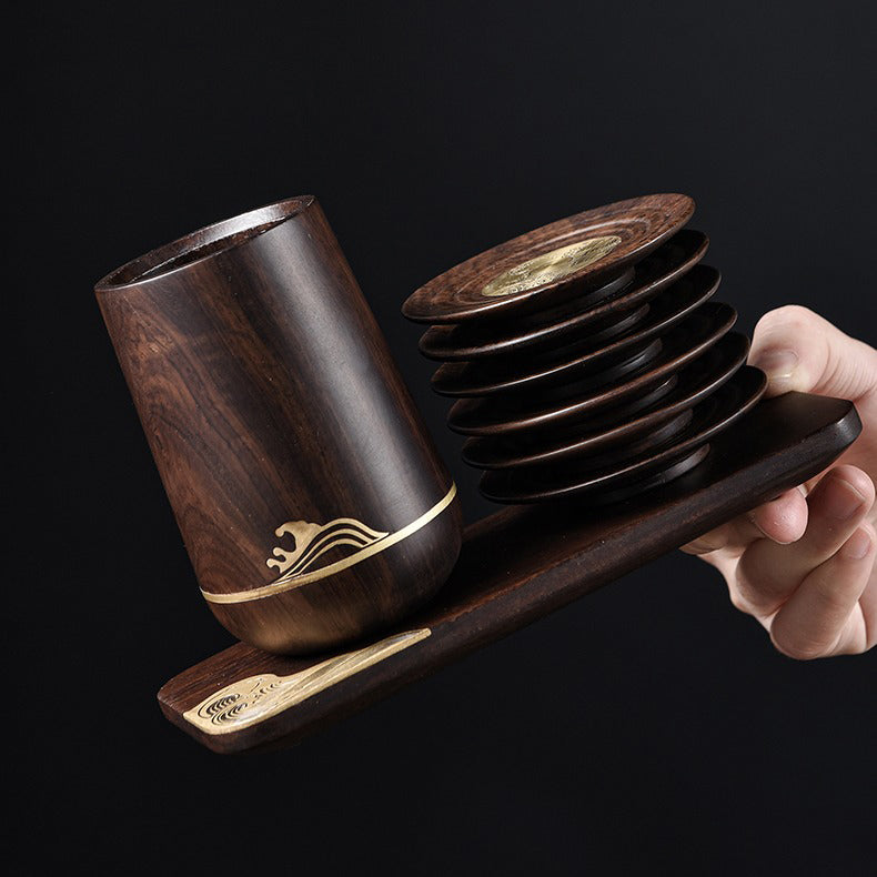 Close-up of the Gong Fu tea utensils including a spoon, funnel, and tweezers.