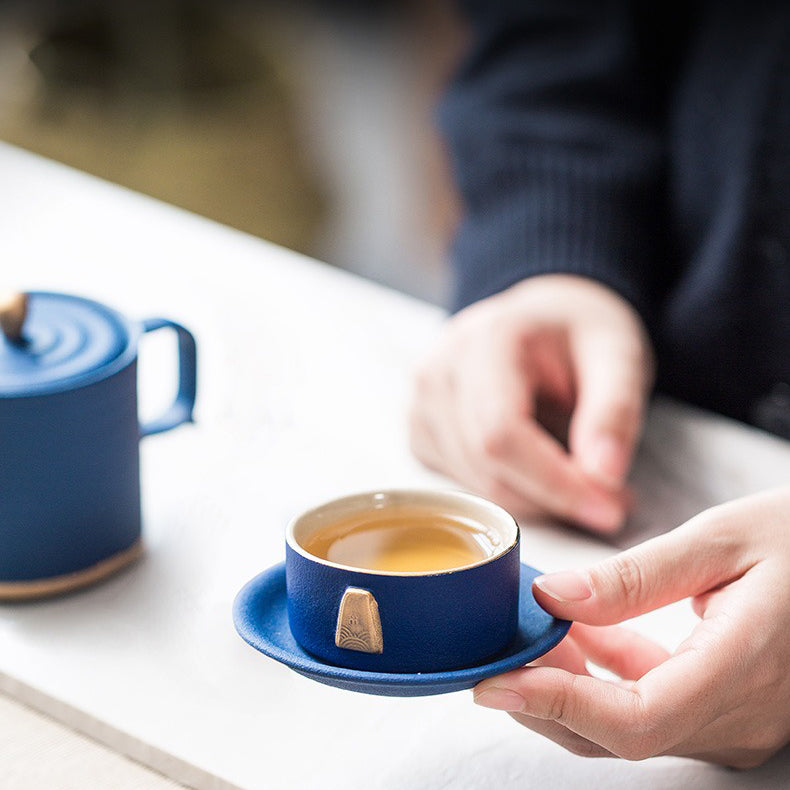 Tea cups and saucers from the best ceramic tea set with gold handle, arranged for a cozy tea gathering.