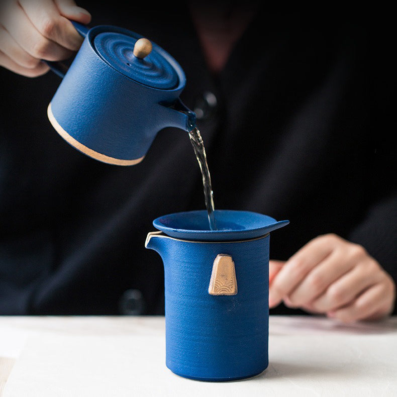 Close-up of the ceramic tea pot from the premium Chinese tea set, highlighting the beautiful glaze and golden handle.