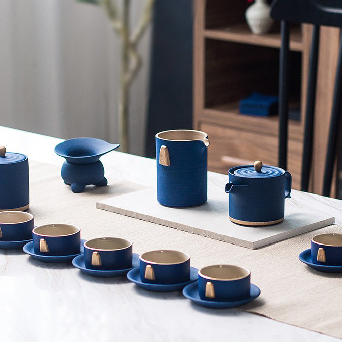 Tea cups and saucers from the best ceramic tea set with gold handle, arranged for a cozy tea gathering.