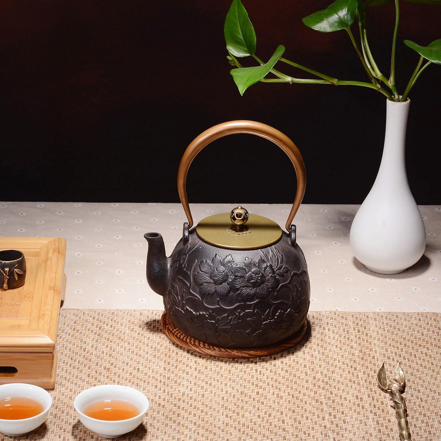 Peony teapot filled with steaming tea, highlighting its functional use in traditional tea brewing.