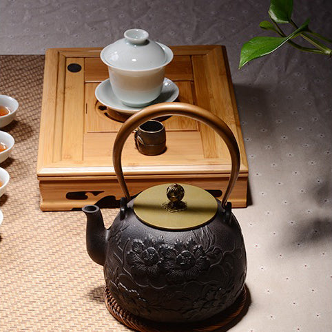 Peony teapot filled with steaming tea, highlighting its functional use in traditional tea brewing.