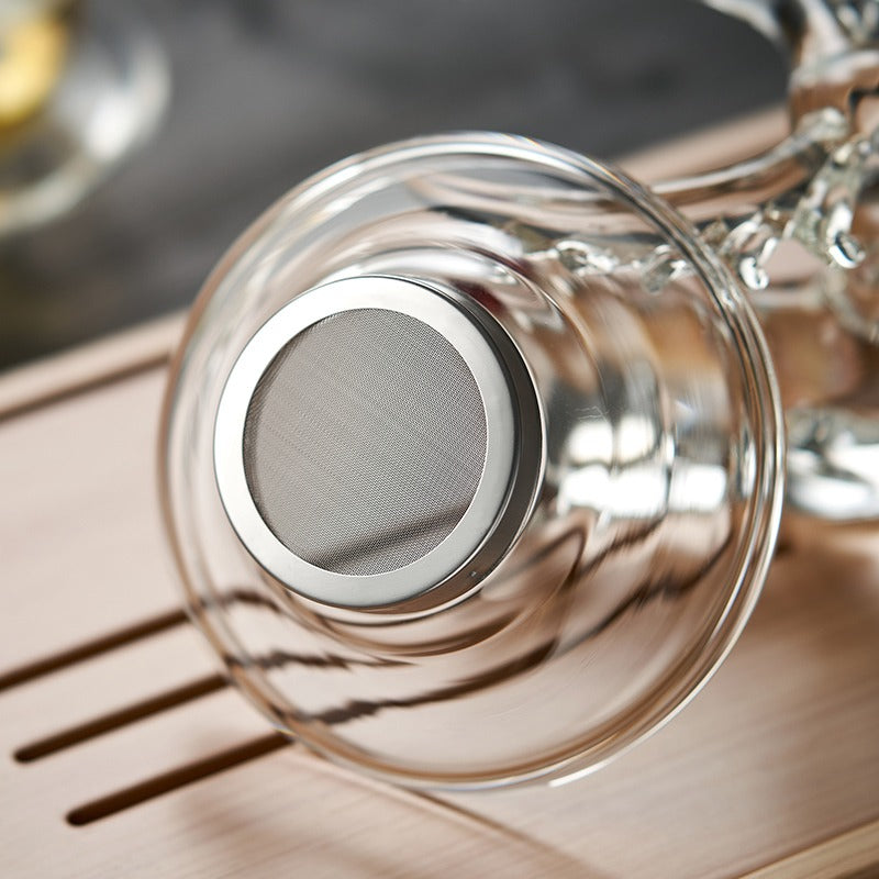 Side view of elegant glass tea strainer with deer holder, showcasing its charming design.