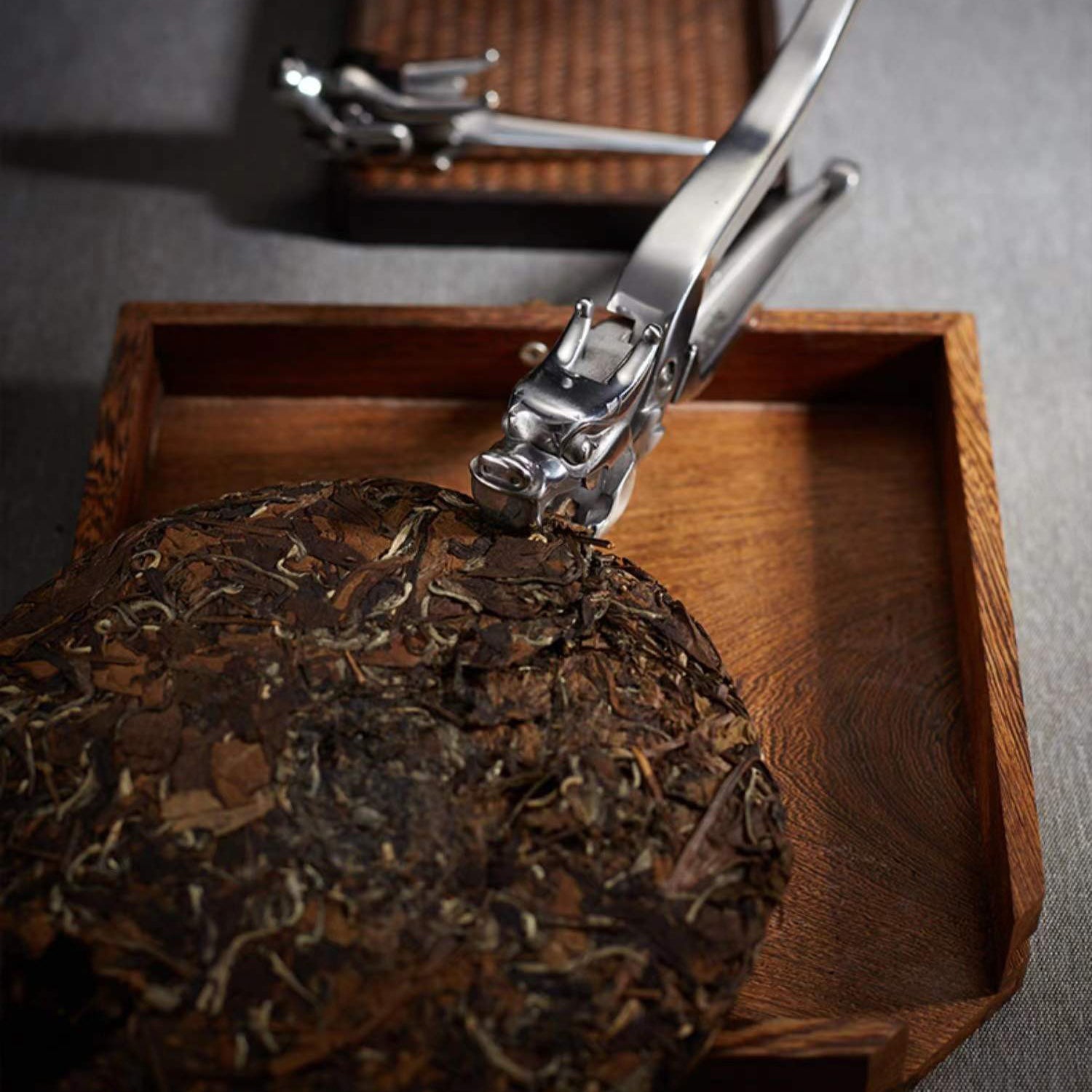 Close-up of stainless steel tea prying tool with textured handle