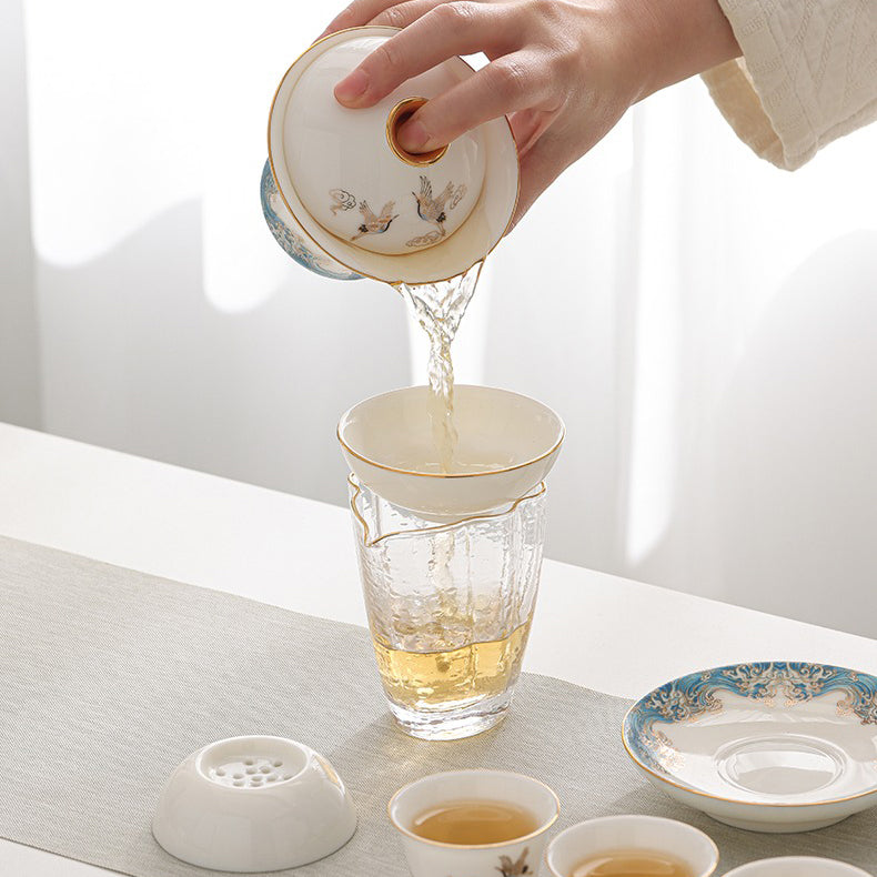 Elegant red-crowned crane ceramic tea set displayed with tea cups and teapot