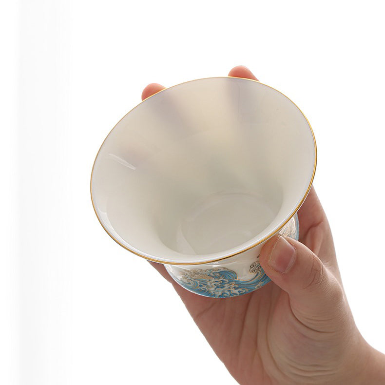 Elegant red-crowned crane ceramic tea set displayed with tea cups and teapot
