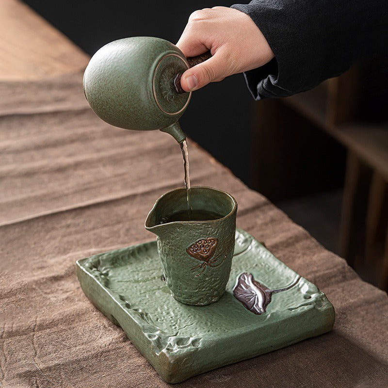 Set of the lotus tea set arranged on a wooden table, highlighting the elegant design and natural colors