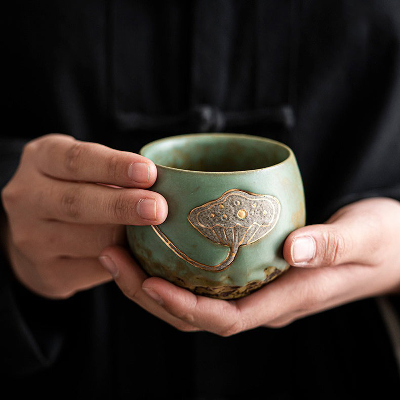 Lifestyle image of the unique high-temperature fired tea cups in use during a traditional tea ceremony.
